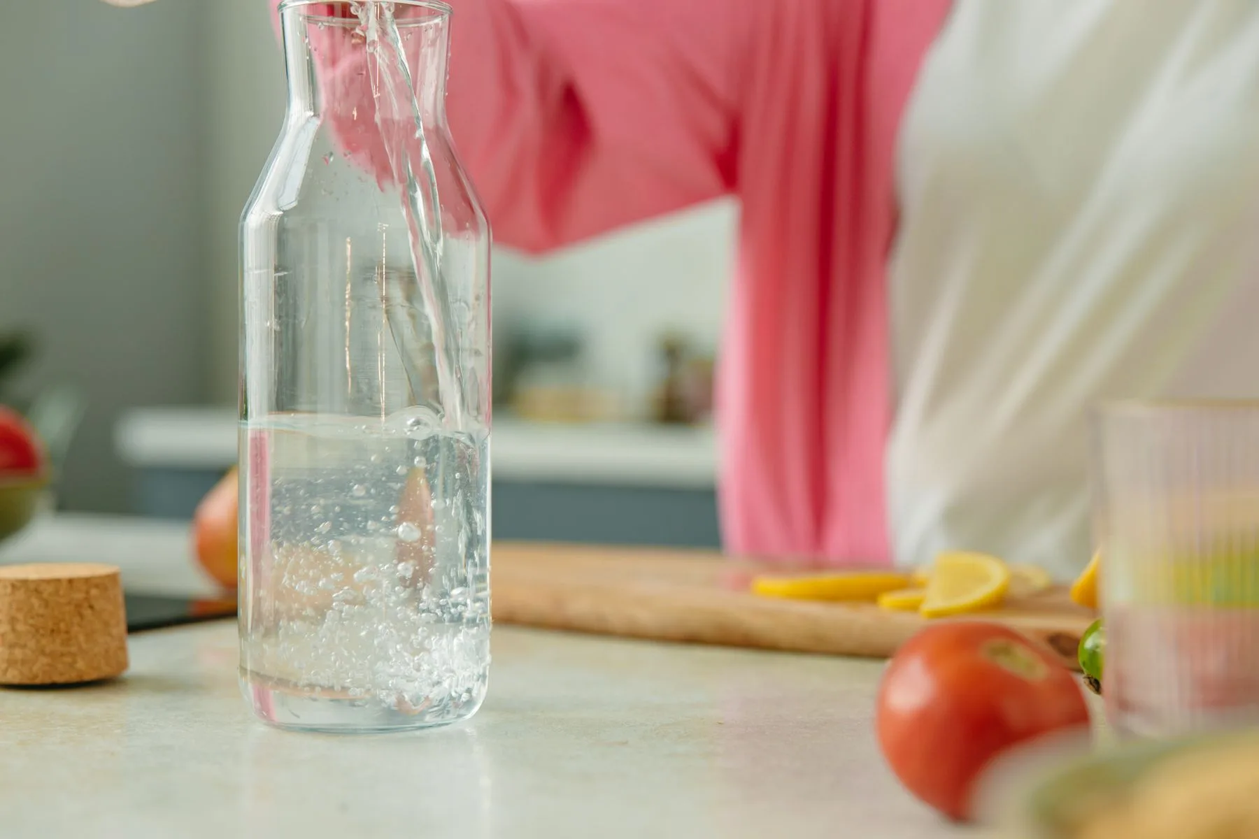 Jarra de agua en una cocina con ingredientes frescos